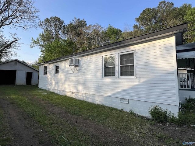 view of side of property with an outdoor structure and a wall mounted AC