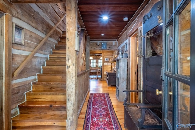 interior space with wooden ceiling, wooden walls, and hardwood / wood-style flooring