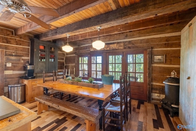 dining space featuring dark wood-type flooring, wood walls, ceiling fan, wooden ceiling, and french doors