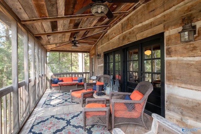 sunroom / solarium with wood ceiling, vaulted ceiling with beams, and ceiling fan