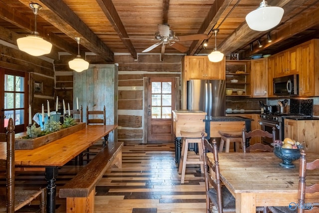 kitchen with appliances with stainless steel finishes, dark hardwood / wood-style floors, ceiling fan, and a wealth of natural light