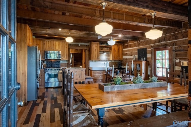 dining space featuring beamed ceiling, wood ceiling, dark hardwood / wood-style floors, and wood walls