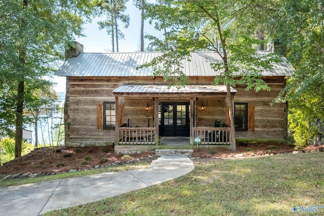 view of front of house featuring a front yard, french doors, and a porch