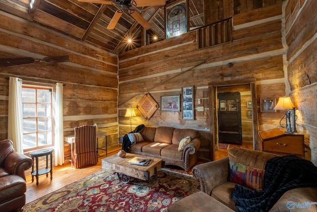 living room featuring ceiling fan, beam ceiling, high vaulted ceiling, wooden ceiling, and hardwood / wood-style floors