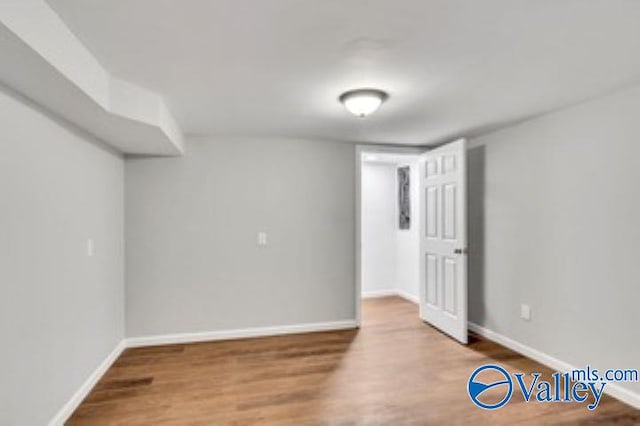 empty room with wood finished floors and baseboards