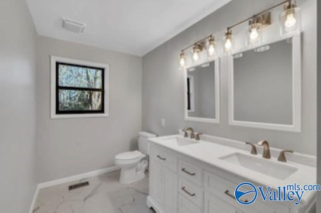 bathroom with visible vents, marble finish floor, baseboards, and a sink