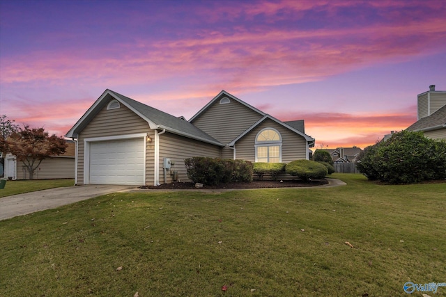 view of front of home with a lawn and a garage