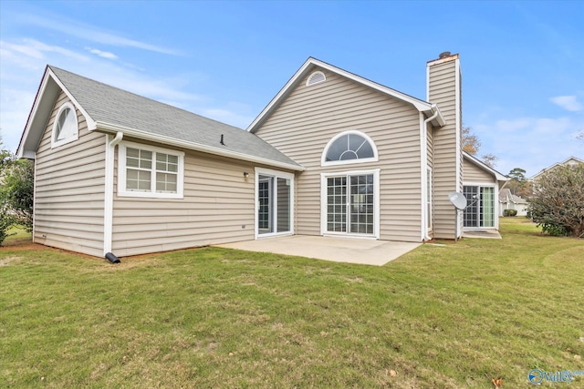 rear view of property featuring a patio area and a lawn