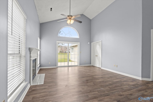 unfurnished living room featuring a textured ceiling, ceiling fan, high vaulted ceiling, and dark hardwood / wood-style floors