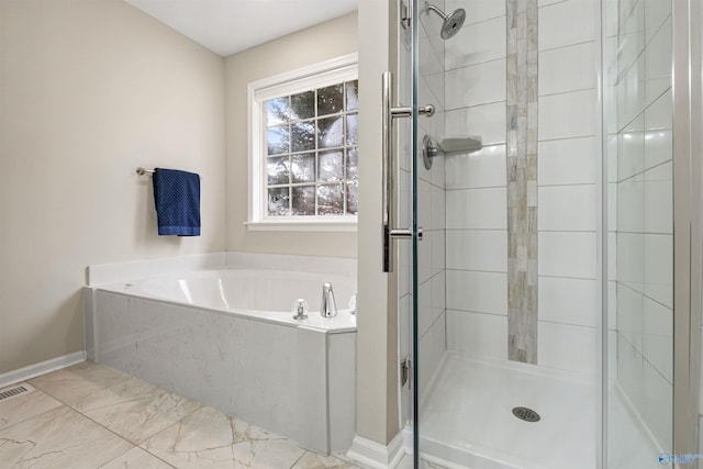 bathroom with separate shower and tub