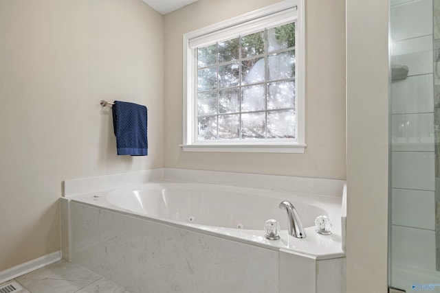 bathroom featuring shower with separate bathtub