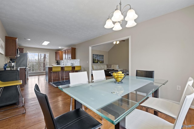 dining room featuring hardwood / wood-style flooring and a notable chandelier