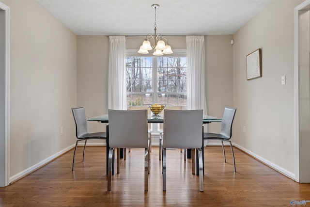 dining room with a notable chandelier and hardwood / wood-style flooring