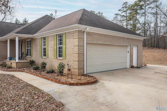 view of side of home with a porch and a garage