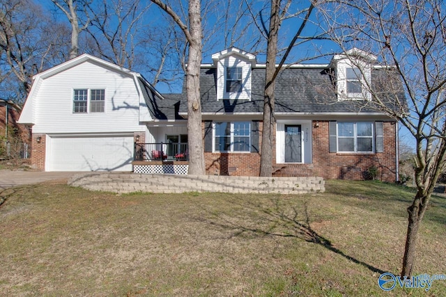 view of front of home with brick siding, a gambrel roof, concrete driveway, roof with shingles, and a front lawn