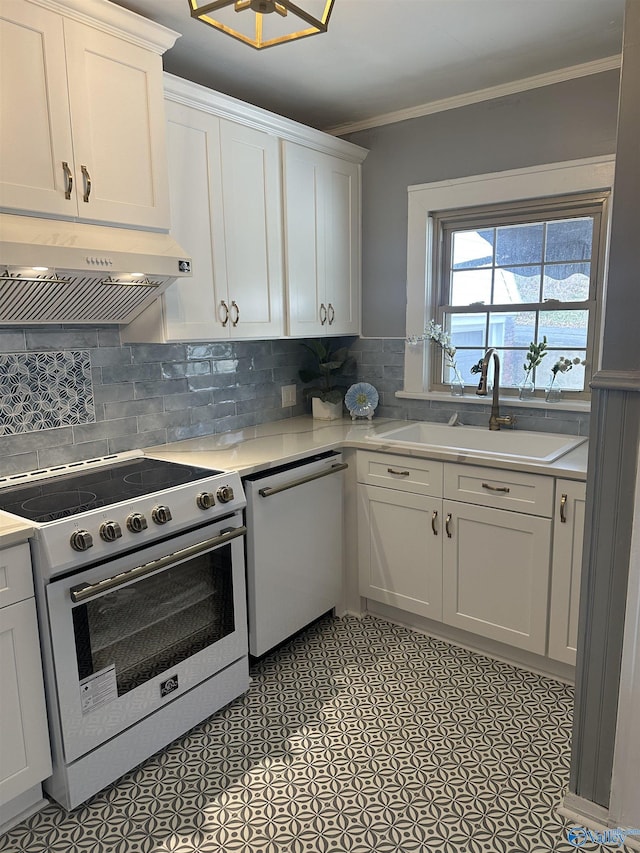 kitchen with light countertops, white dishwasher, under cabinet range hood, and stainless steel electric range