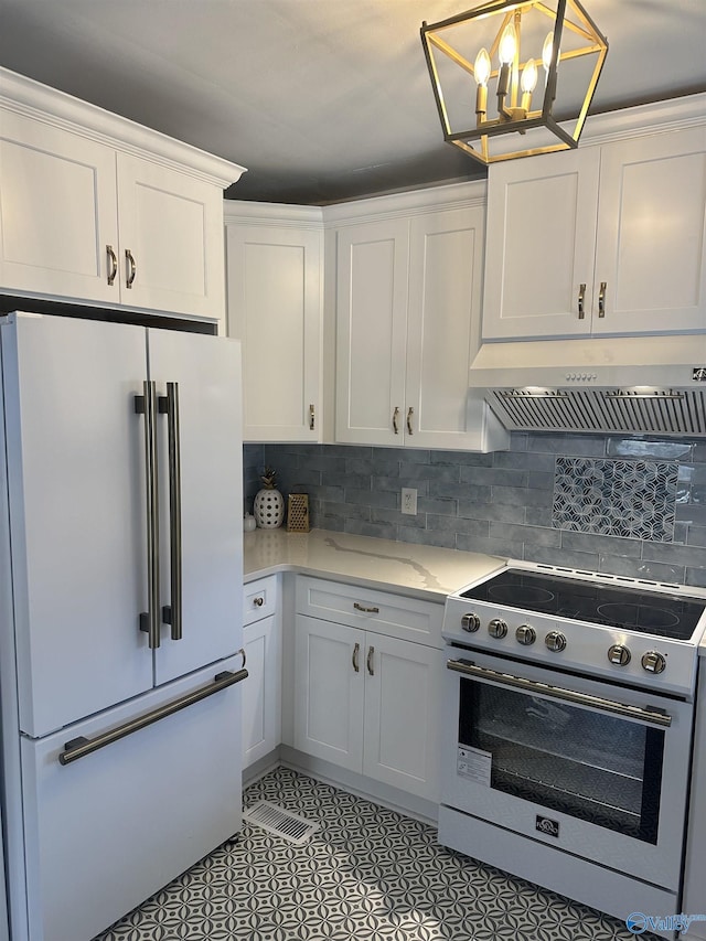 kitchen featuring tasteful backsplash, white cabinets, ventilation hood, and high quality appliances