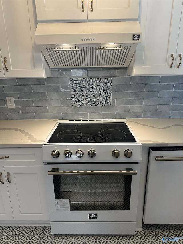 kitchen with light stone counters, white cabinetry, electric range, and exhaust hood