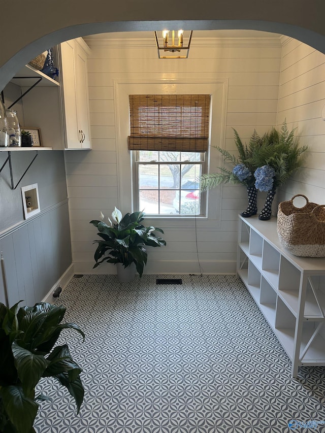 washroom with laundry area, tile patterned flooring, and arched walkways