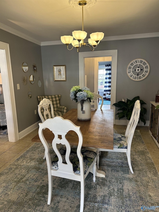 dining space featuring ornamental molding, tile patterned flooring, a notable chandelier, and baseboards