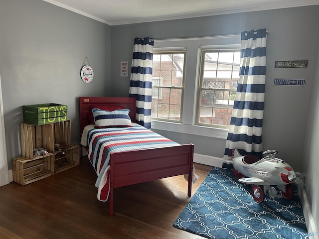 bedroom featuring baseboards, ornamental molding, and dark wood-type flooring