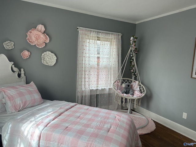 bedroom with ornamental molding, wood finished floors, and baseboards