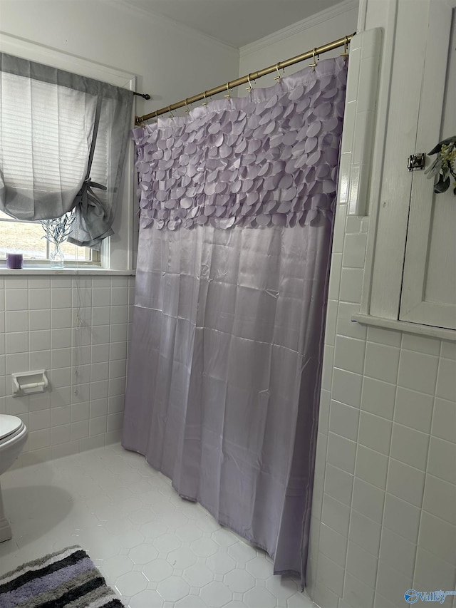 bathroom with ornamental molding, tile walls, and toilet