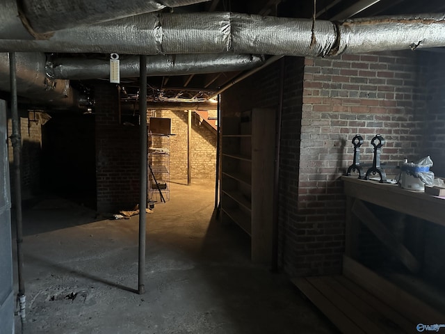 unfinished below grade area with brick wall