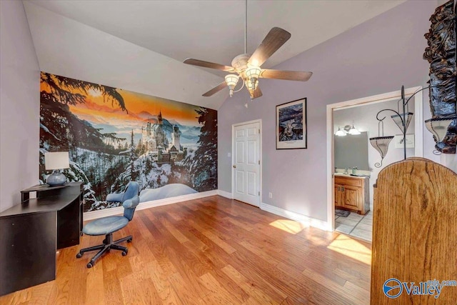 office area featuring lofted ceiling, ceiling fan, and light hardwood / wood-style flooring