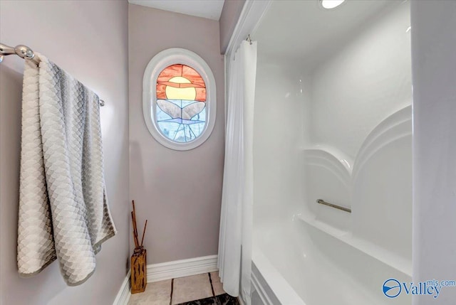 bathroom with tile patterned floors and walk in shower