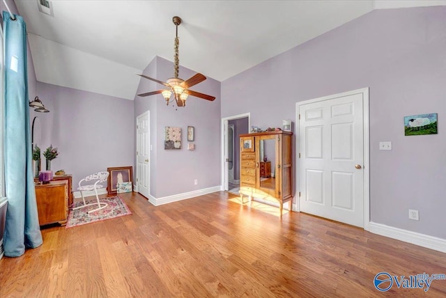 interior space featuring lofted ceiling, ceiling fan, and light hardwood / wood-style flooring