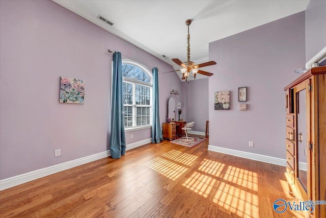 interior space with ceiling fan, lofted ceiling, and hardwood / wood-style flooring