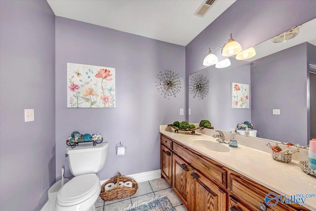 bathroom featuring toilet, vanity, and tile patterned floors