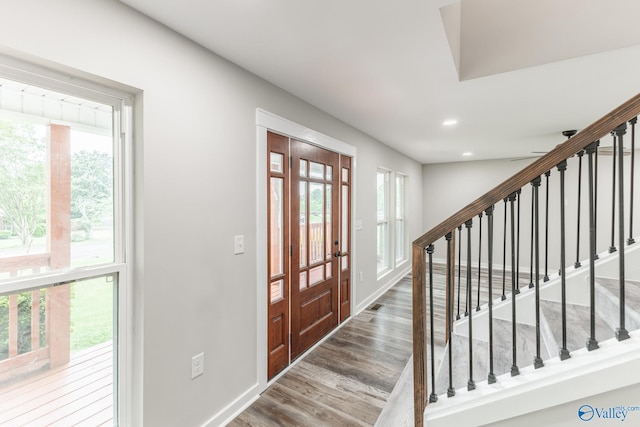 entrance foyer with french doors, stairs, wood finished floors, baseboards, and recessed lighting