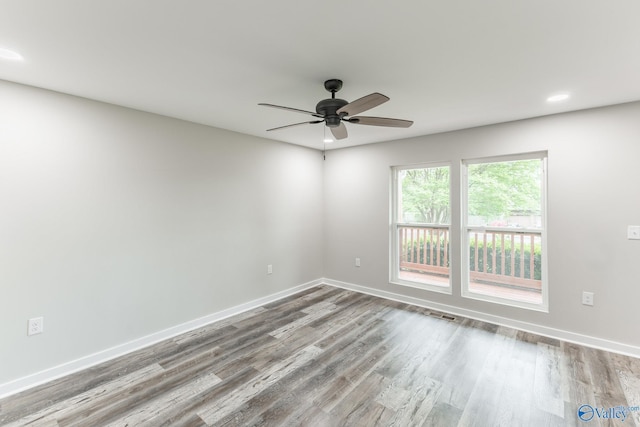 spare room with a ceiling fan, baseboards, recessed lighting, and wood finished floors