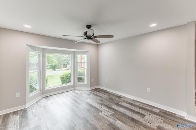 unfurnished room featuring baseboards, ceiling fan, recessed lighting, and wood finished floors
