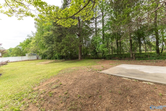 view of yard with fence and a patio