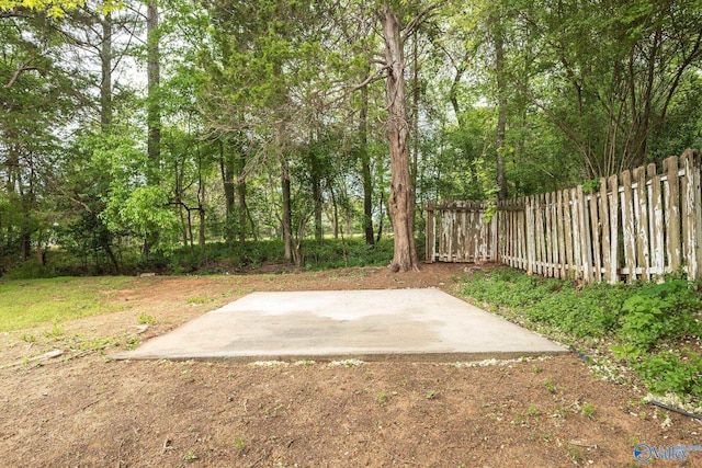 view of yard featuring fence and a patio area