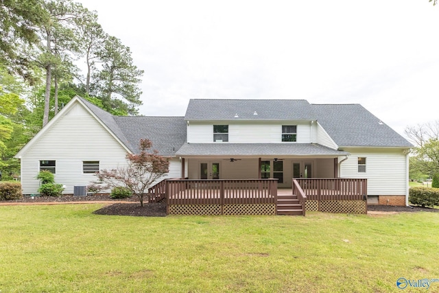 back of property with roof with shingles, a yard, a deck, and french doors