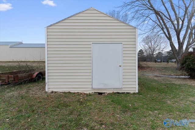 view of outbuilding featuring a lawn