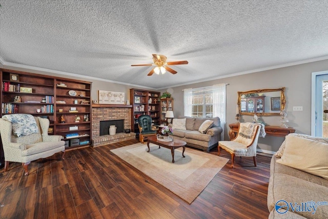 living room featuring a brick fireplace, dark wood-type flooring, ornamental molding, and a textured ceiling