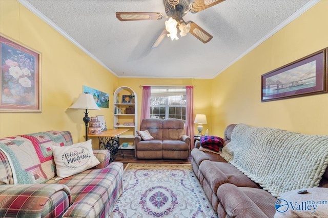 living room with ceiling fan, ornamental molding, a textured ceiling, and light hardwood / wood-style flooring