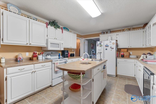 kitchen featuring white cabinetry, white appliances, a kitchen island with sink, and a textured ceiling