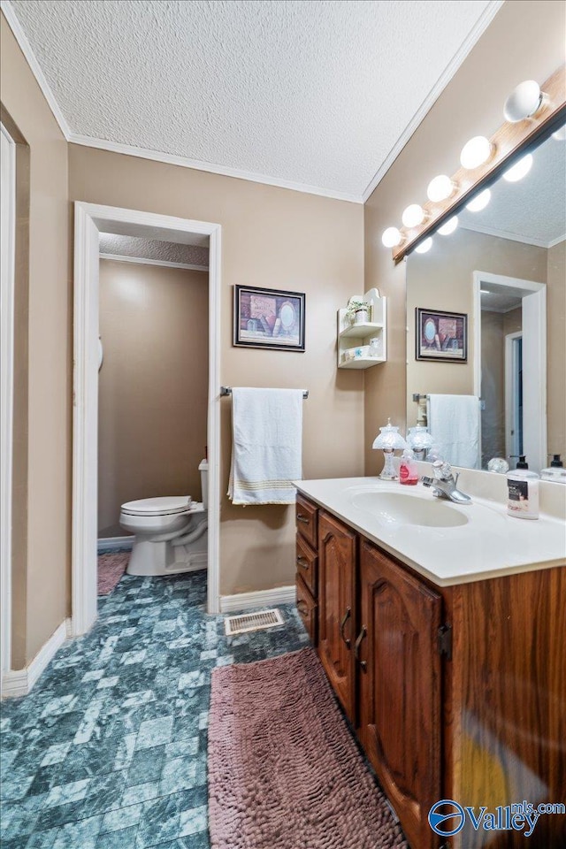 bathroom with crown molding, vanity, toilet, and a textured ceiling