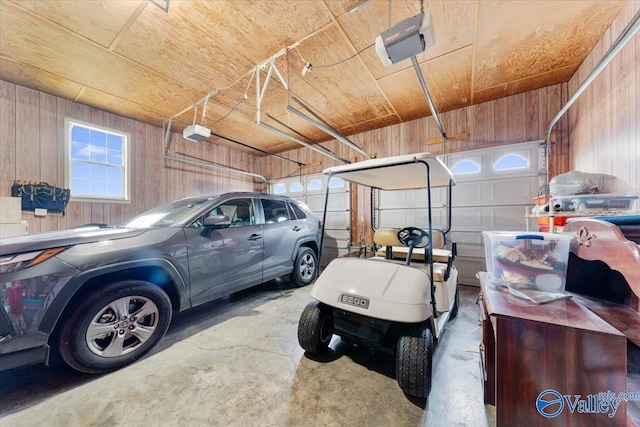 garage with wooden ceiling, a garage door opener, and wood walls