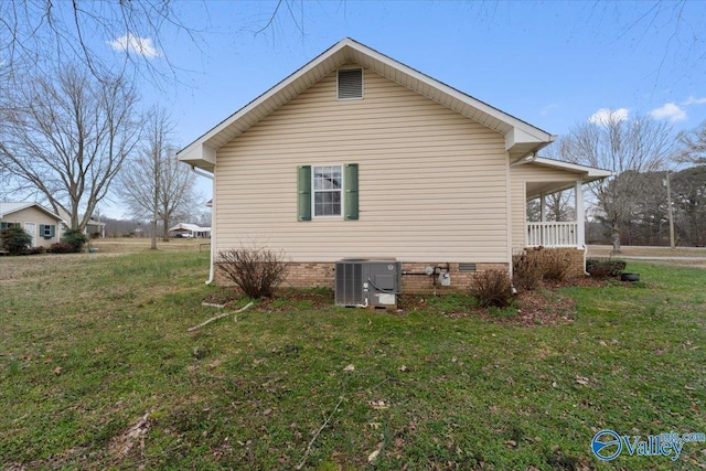 view of property exterior with a yard, central AC, and a porch