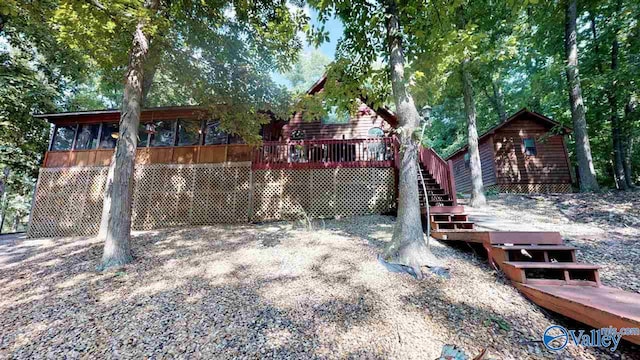 view of yard featuring a sunroom and stairway