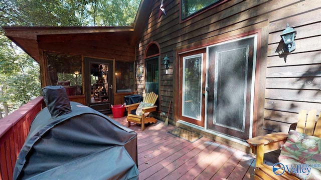 wooden terrace featuring a grill
