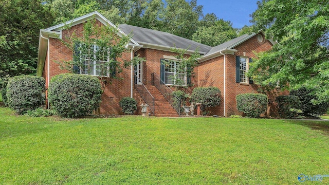 2317 Little Cove Rd, Owens Cross Roads, AL 35763 - view of front facade with brick siding and a front lawn