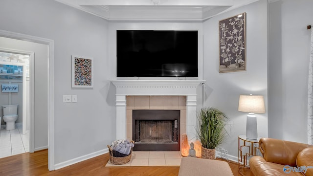 2317 Little Cove Rd, Owens Cross Roads, AL 35763 - living room with wood finished floors, a fireplace, and ornamental molding